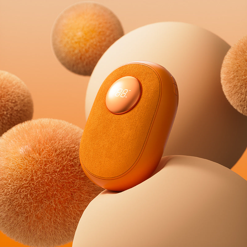 Orange Bombom rechargeable digital hand warmer with LED temperature display on soft textured surface